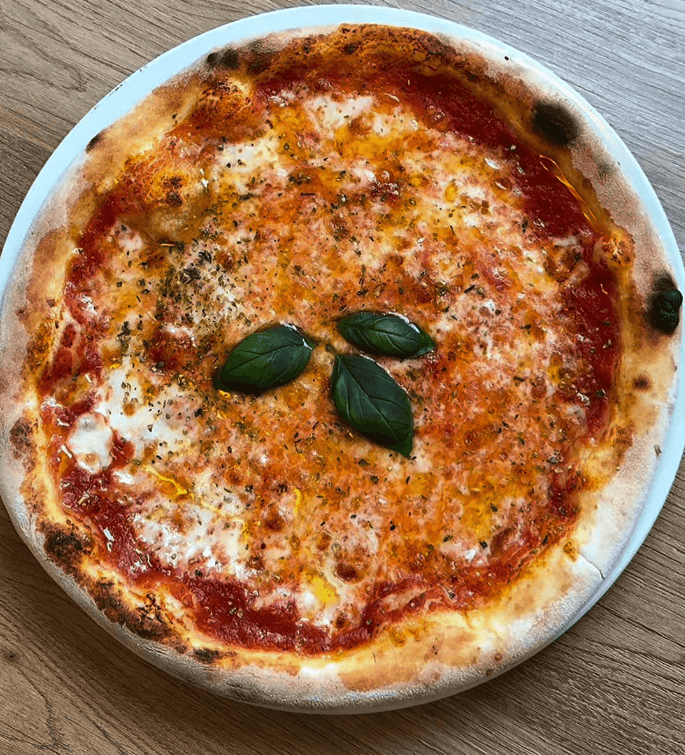 Pizza Margherita mit frischem Basilikum